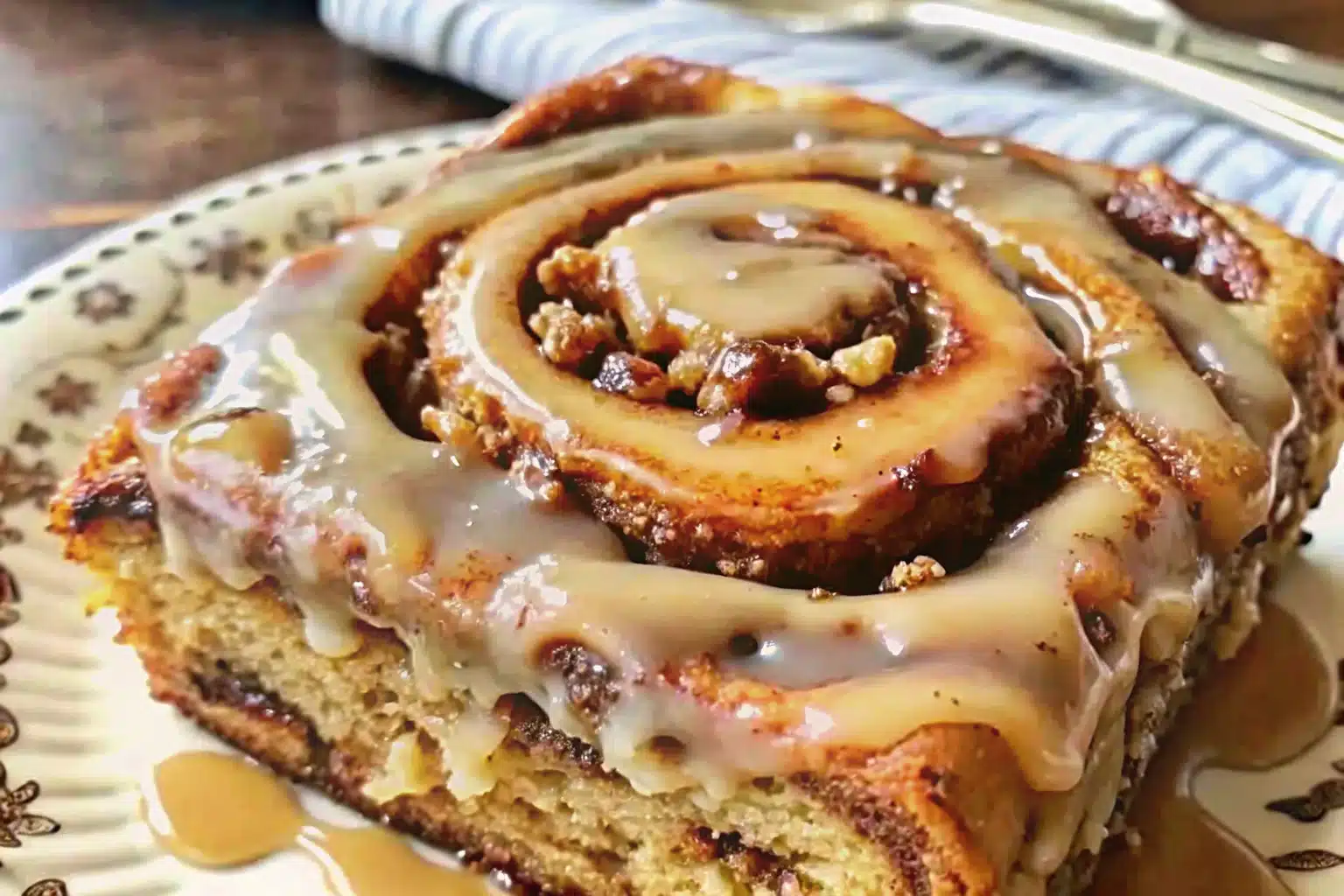 A freshly prepared Banana Bread Cinnamon Rolls recipe with golden swirls, ripe banana filling, and creamy yogurt glaze, served warm on a white plate