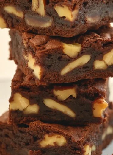 Delicious homemade brownies with crispy edges and fudgy centers, topped with chocolate.