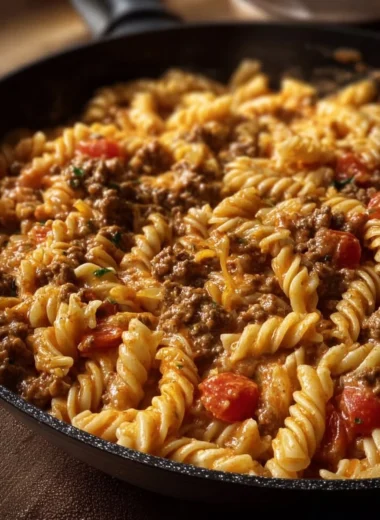 Delicious creamy cheesy Rotel pasta in a bowl topped with fresh herbs.