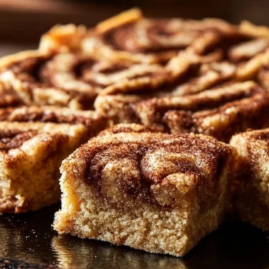 Delicious Cinnamon Swirl Snickerdoodle Blondies freshly baked on a cooling rack.