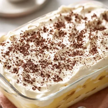 Homemade banana pudding bars served on a plate with fresh banana slices
