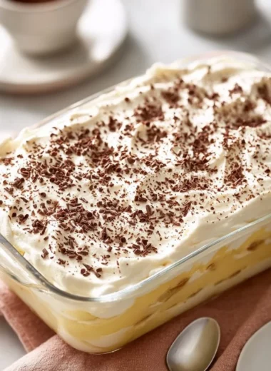 Homemade banana pudding bars served on a plate with fresh banana slices