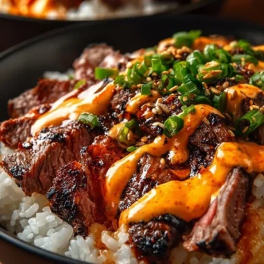 Korean BBQ Steak Rice Bowls with Spicy Cream Sauce on a wooden table