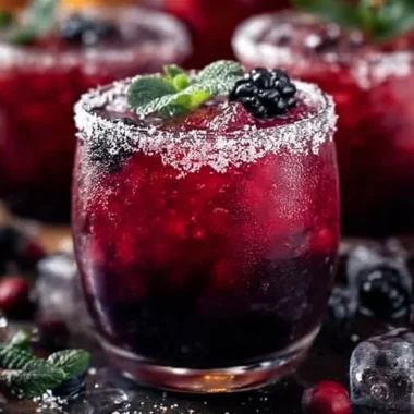 Magical Midnight Frost Christmas Punch served in a festive glass with decorations.