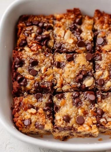 Delicious German chocolate cookie bars topped with coconut and nuts.