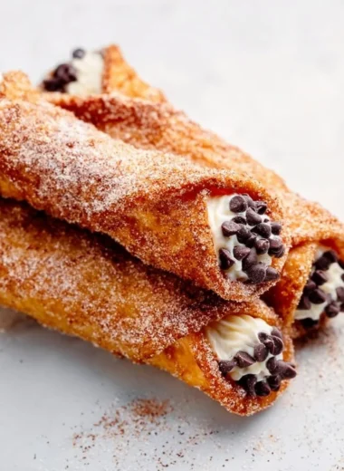 Delicious churro cannolis filled with creamy filling and dusted with cinnamon sugar