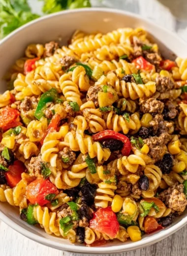 Colorful Cowboy Pasta Salad with fresh vegetables and dressing in a bowl