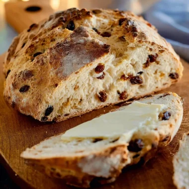 Freshly baked Irish Soda Bread on a wooden cutting board.