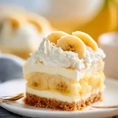 No Bake Banana Cream Pudding Cheesecake topped with banana slices and whipped cream