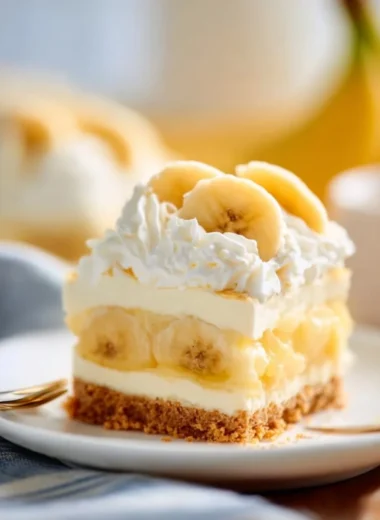 No Bake Banana Cream Pudding Cheesecake topped with banana slices and whipped cream