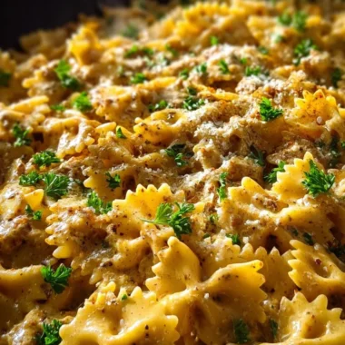 Cajun Cream Cheese Alfredo Bowties topped with spiced ground beef in a bowl