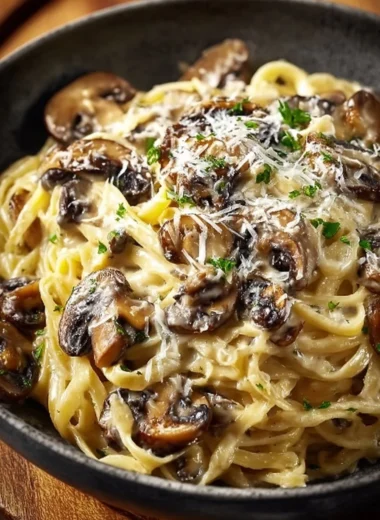 Creamy mushroom gruyere pasta in a bowl, garnished with herbs