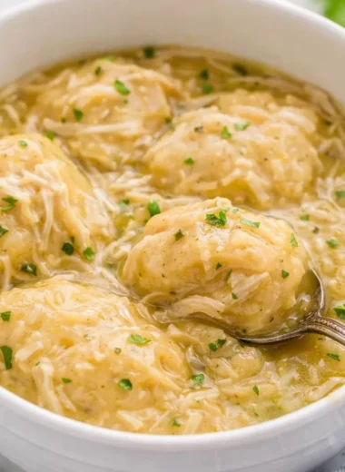 Delicious bowl of Crockpot Chicken and Dumplings with fresh herbs and vegetables