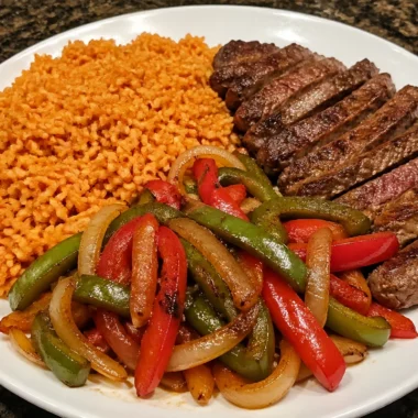 Sizzling steak fajita rice plate with colorful peppers and onions