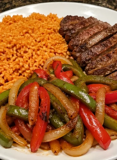 Sizzling steak fajita rice plate with colorful peppers and onions