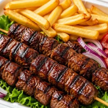 Smoky beef skewers box lunch with grilled beef on skewers and fresh sides.