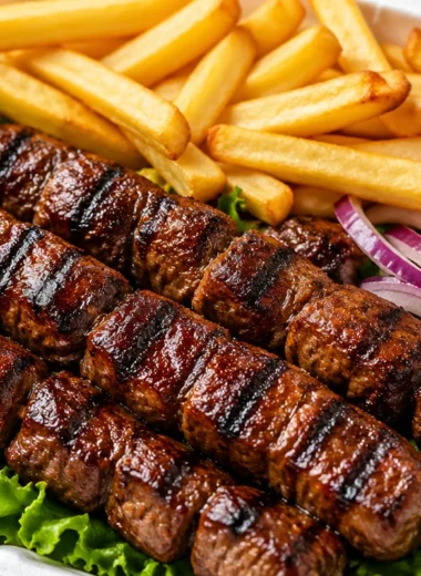 Smoky beef skewers box lunch with grilled beef on skewers and fresh sides.