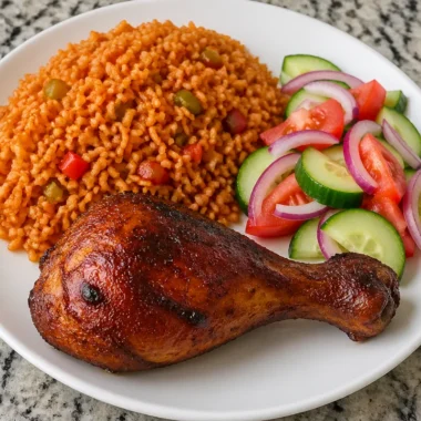 Delicious Spicy Chicken Plate with Jollof rice and vibrant salad