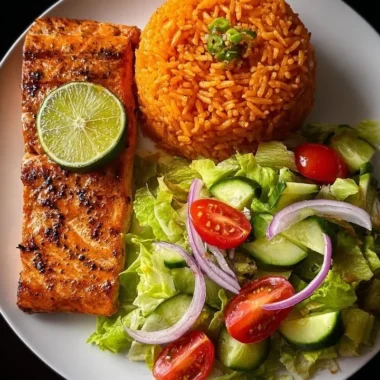 Citrusy lime salmon dish served with Spanish rice and a garden salad