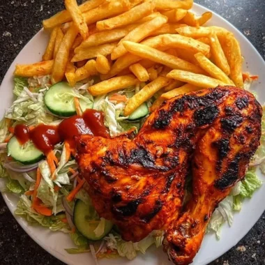 Flame-grilled chicken leg quarters served with fries and salad