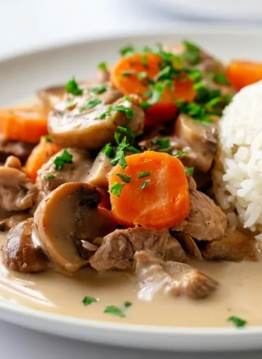 Creamy Blanquette de Veau served in a white bowl with fresh herbs
