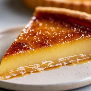 Creamy French custard tart topped with fresh fruit and garnished with mint