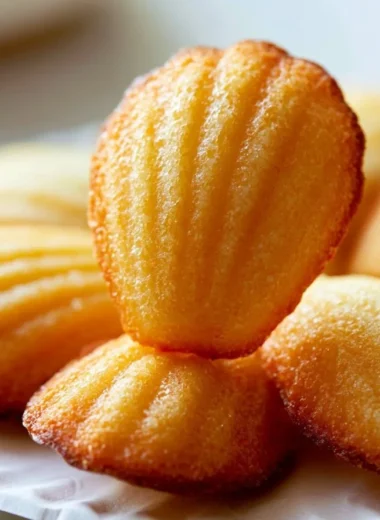 Classic French madeleines sponge cakes freshly baked and served on a plate