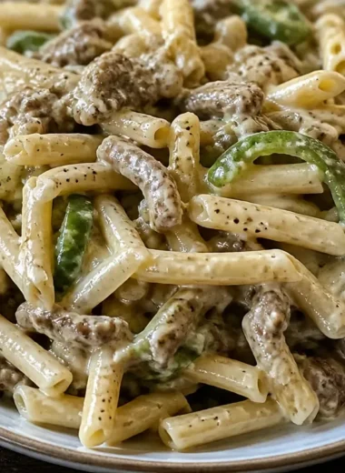 One-Pot Philly Cheese Steak Pasta in a skillet with toppings