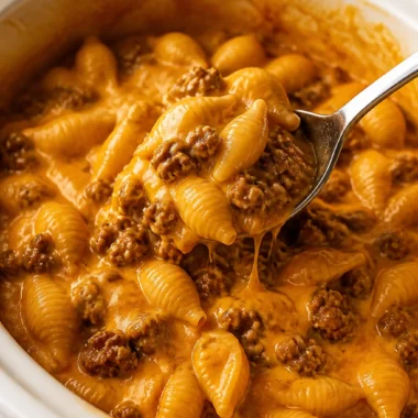 Crock Pot Taco Shells and Cheese dish garnished with fresh herbs