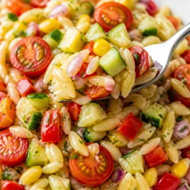 Refreshing summer orzo pasta salad with vegetables and herbs